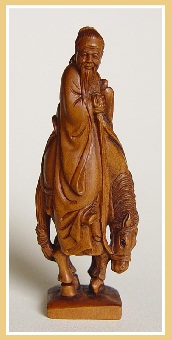 PALMHOUTEN NETSUKE WIJZE OUDE MAN OP PAARD. JAPAN.